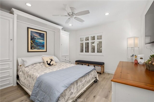 bedroom with ceiling fan and light wood-type flooring