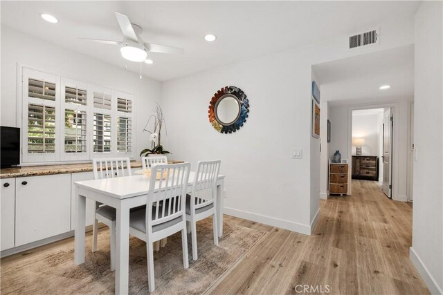 dining area featuring ceiling fan and light wood-type flooring