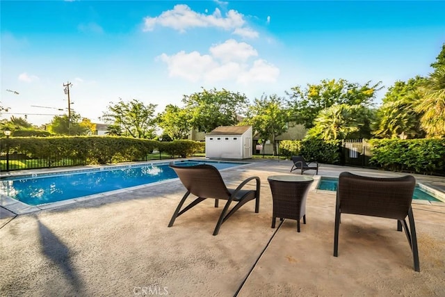 view of swimming pool with a storage unit