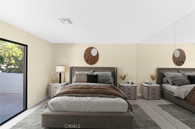 bedroom with access to exterior and light colored carpet