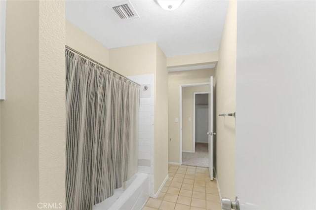 bathroom with shower / tub combo and tile patterned flooring