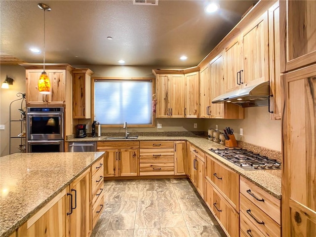 kitchen featuring pendant lighting, sink, stainless steel appliances, light stone counters, and light brown cabinets