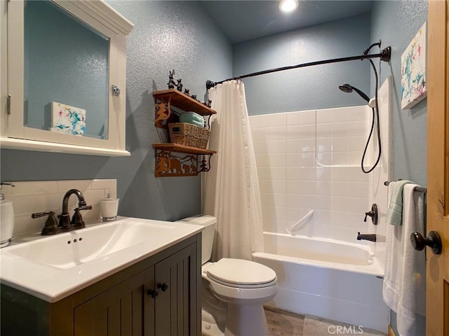 full bathroom featuring shower / tub combo with curtain, vanity, and toilet