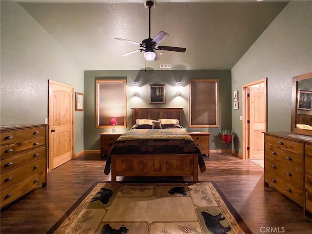 bedroom featuring vaulted ceiling, dark wood-type flooring, and ceiling fan