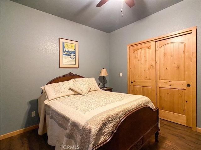 bedroom with ceiling fan and dark hardwood / wood-style flooring