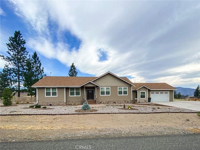 single story home with a garage and a mountain view