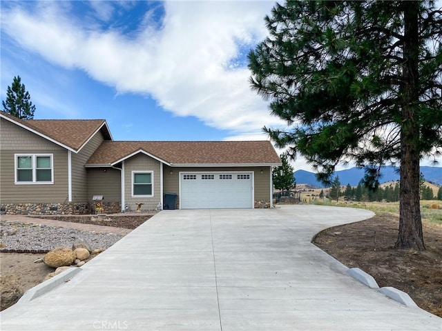 ranch-style home featuring a mountain view and a garage