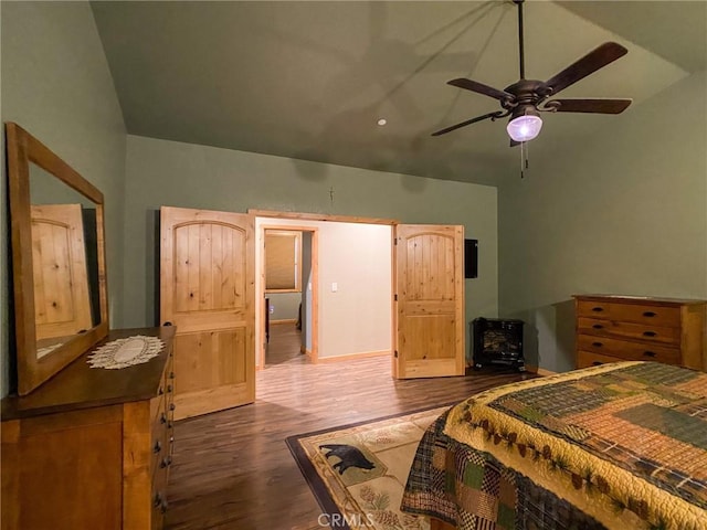 bedroom with ceiling fan, dark hardwood / wood-style floors, and high vaulted ceiling