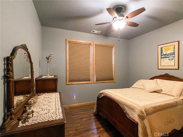 bedroom with dark hardwood / wood-style floors and ceiling fan