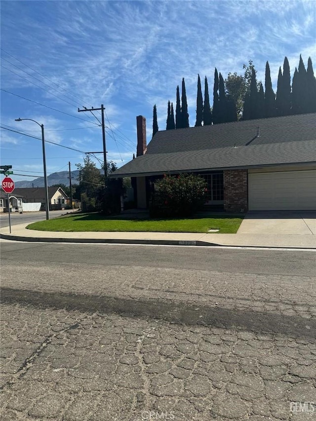 view of front of property with a garage and a front yard