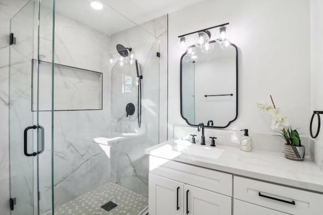 bathroom featuring vanity and a shower with shower door