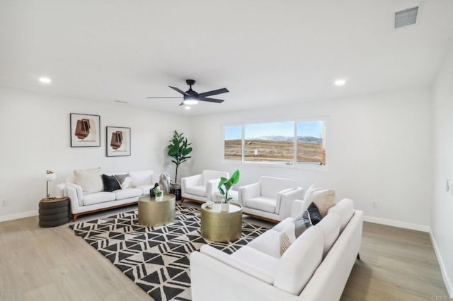 living room with ceiling fan and wood-type flooring