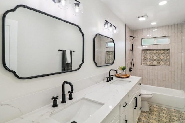 full bathroom with vanity, toilet, and tiled shower / bath combo