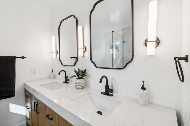 bathroom featuring vanity and an enclosed shower