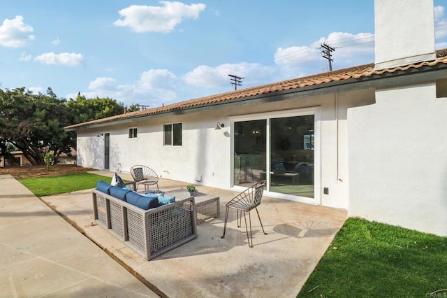 back of property featuring an outdoor living space and a patio