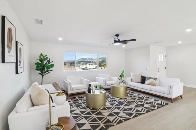 living room with ceiling fan and wood-type flooring