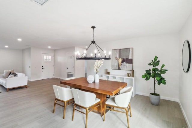 dining room featuring light hardwood / wood-style floors and a notable chandelier