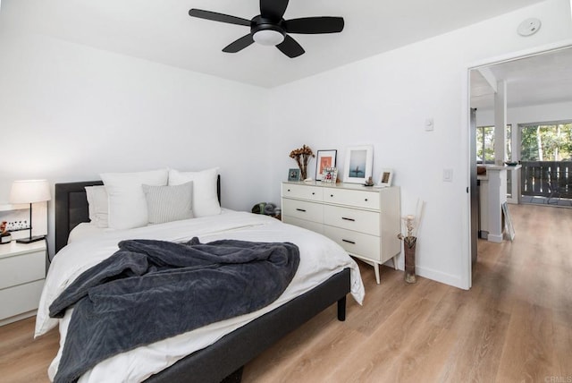 bedroom with ceiling fan and light hardwood / wood-style floors