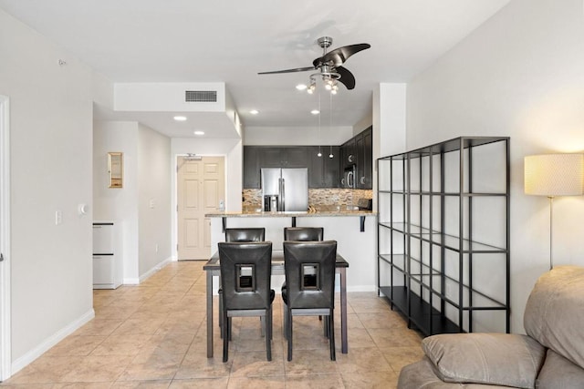 dining space featuring light tile patterned floors and ceiling fan