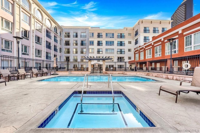 view of pool with a community hot tub and a patio area