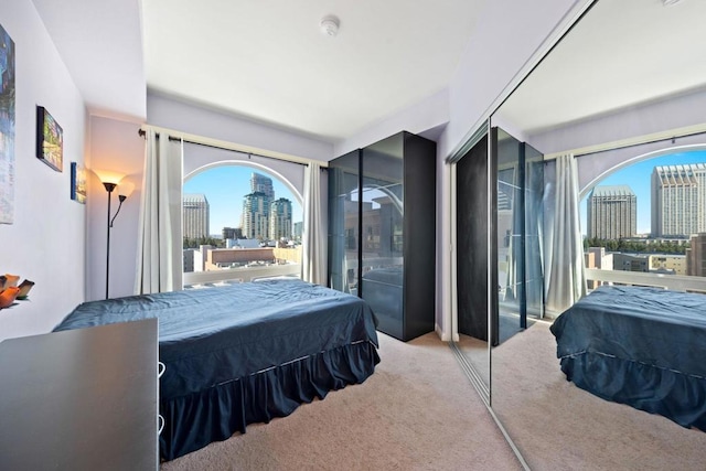 bedroom featuring access to exterior and light colored carpet