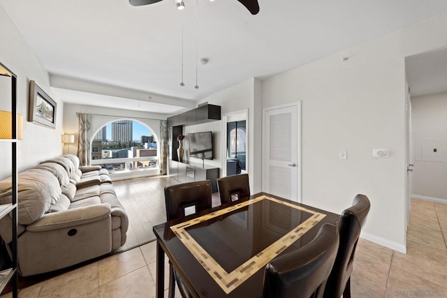 tiled dining room with ceiling fan