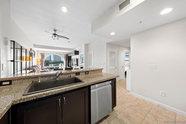 kitchen with sink, ceiling fan, dark brown cabinets, light stone counters, and stainless steel dishwasher