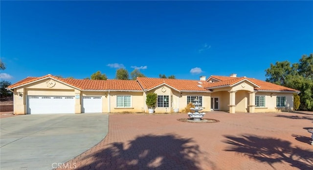 mediterranean / spanish house featuring a garage