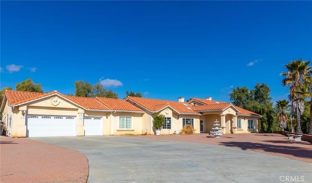 mediterranean / spanish-style home featuring a garage