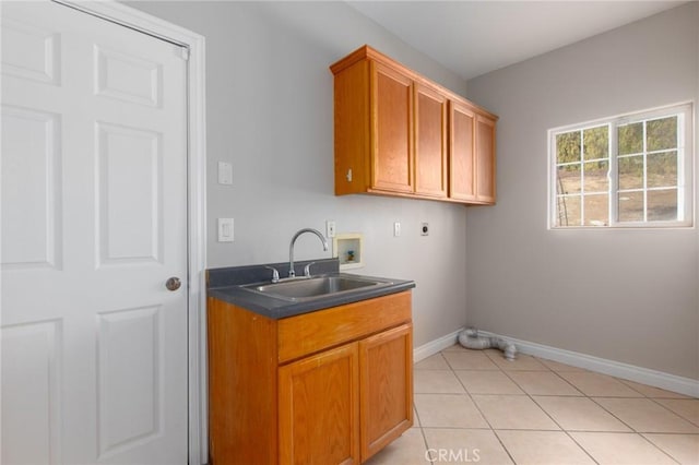 laundry area with sink, electric dryer hookup, hookup for a washing machine, cabinets, and light tile patterned flooring