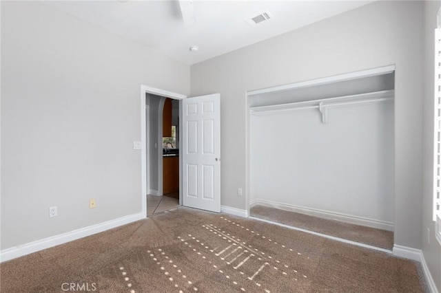 unfurnished bedroom with carpet floors and a closet