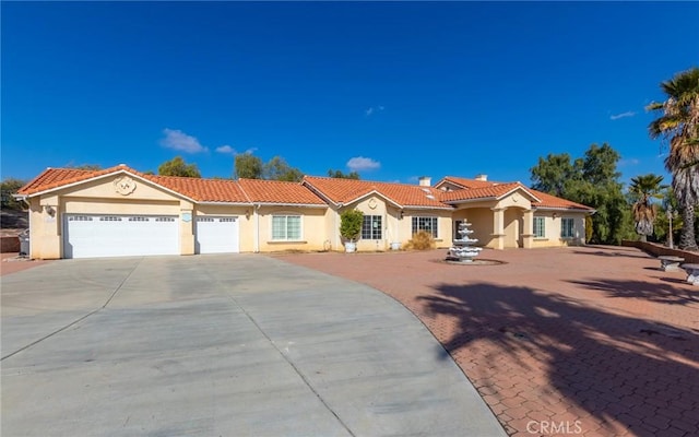 mediterranean / spanish home with a garage