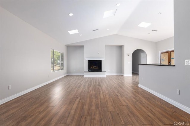 unfurnished living room with lofted ceiling and dark hardwood / wood-style floors