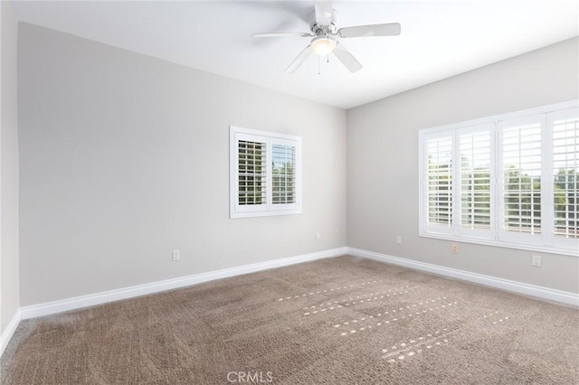 carpeted spare room with ceiling fan