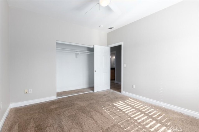 unfurnished bedroom featuring carpet floors, a closet, and ceiling fan