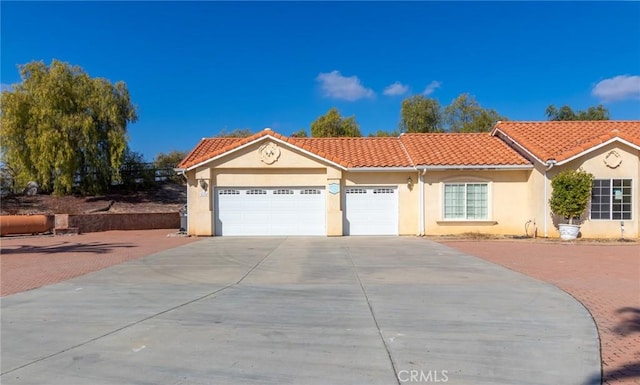 mediterranean / spanish-style house featuring a garage