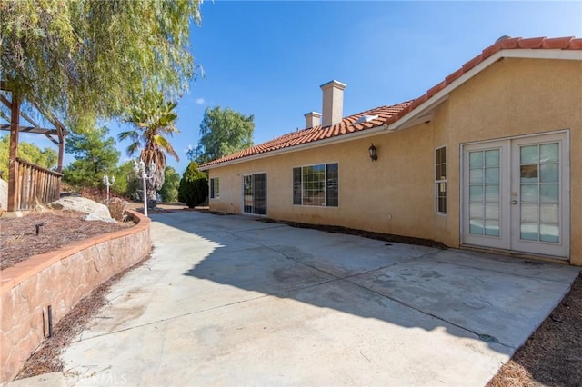 rear view of property featuring french doors and a patio