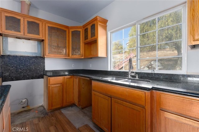 kitchen with dark hardwood / wood-style flooring, sink, and dark stone countertops