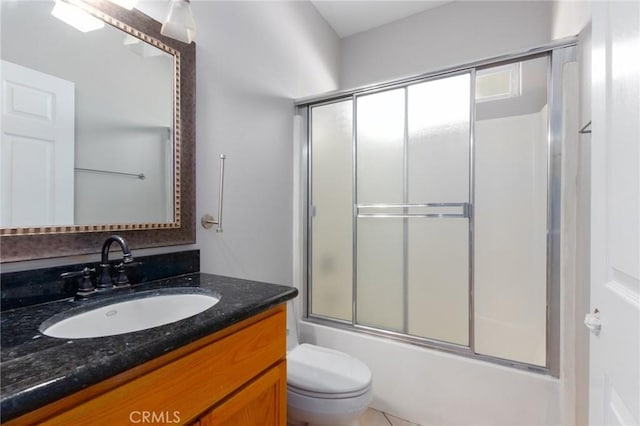 full bathroom featuring enclosed tub / shower combo, vanity, and toilet