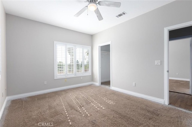 unfurnished bedroom with carpet floors, a closet, and ceiling fan