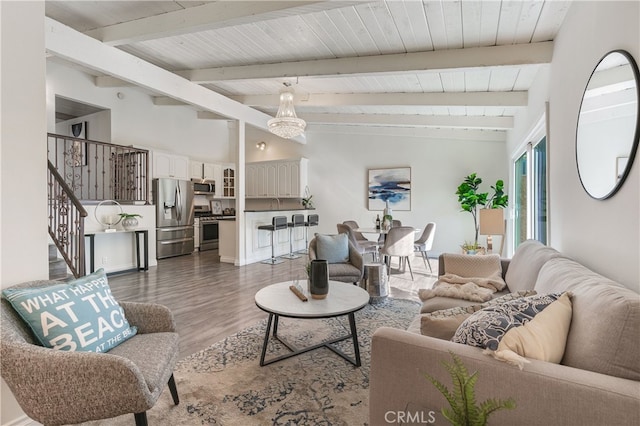 living room featuring vaulted ceiling with beams, wood ceiling, and dark wood-type flooring