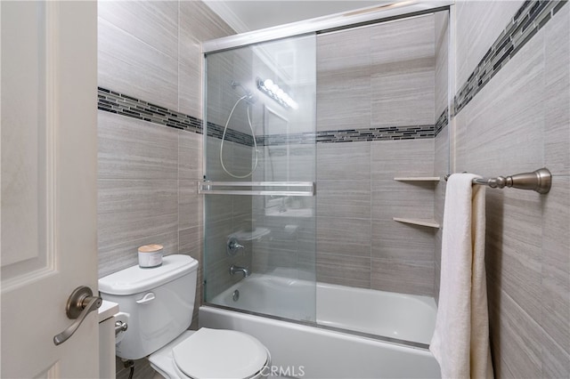 bathroom featuring bath / shower combo with glass door and toilet