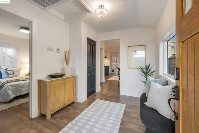 interior space featuring lofted ceiling and dark hardwood / wood-style floors