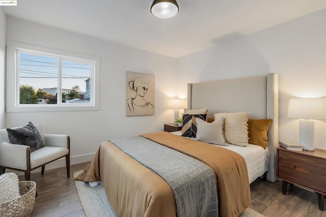 bedroom with dark hardwood / wood-style flooring