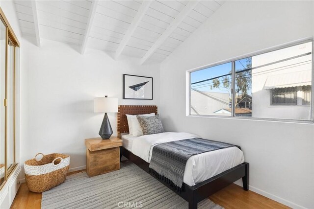 bedroom with wood ceiling, light hardwood / wood-style flooring, and lofted ceiling with beams