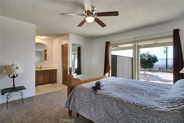 carpeted bedroom with sink, ceiling fan, connected bathroom, a textured ceiling, and access to outside