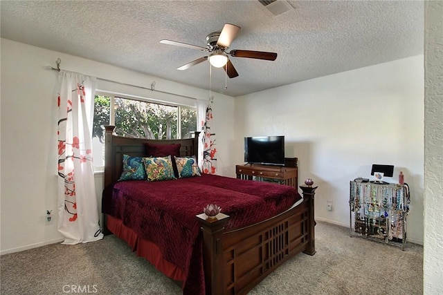 bedroom featuring ceiling fan, light carpet, and a textured ceiling