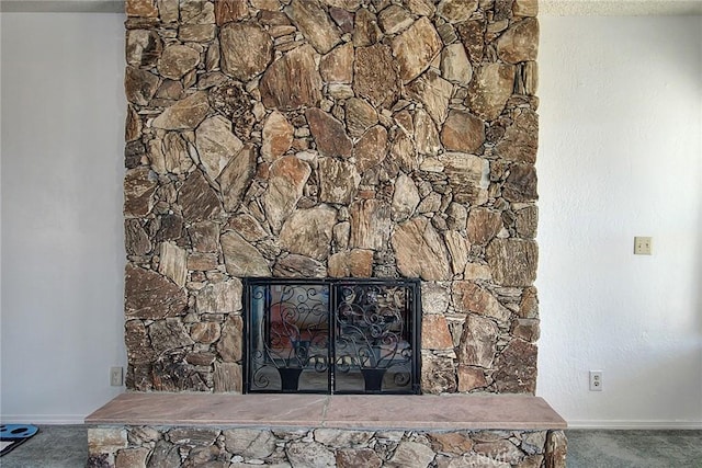 interior details with carpet floors and a fireplace