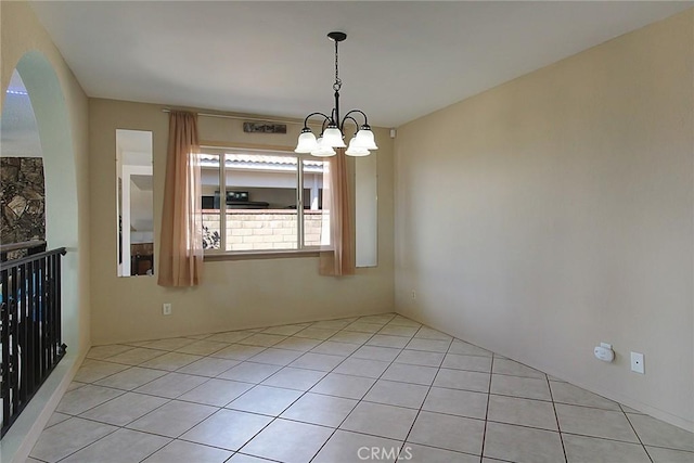 unfurnished dining area with a notable chandelier and light tile patterned floors