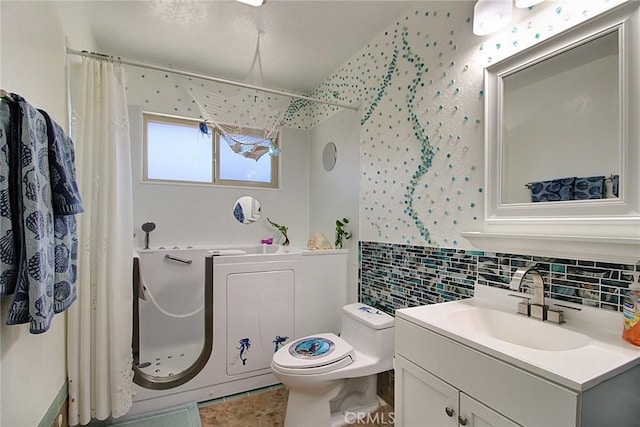 bathroom with walk in shower, vanity, and toilet